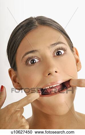 Female young adult face; stretching mouth open View Large Photo Image Stock Image - Female young adult face; stretching mouth open. Fotosearch