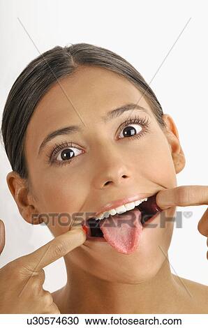 Female young adult face; stretching mouth open; tongue out View Large Photo Image Stock Image - Female young adult face; stretching mouth open; tongue out. Fotosearch