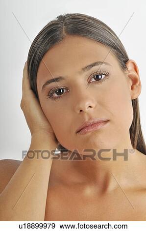 Stock Photo - Female young adult; hand holding head. Fotosearch