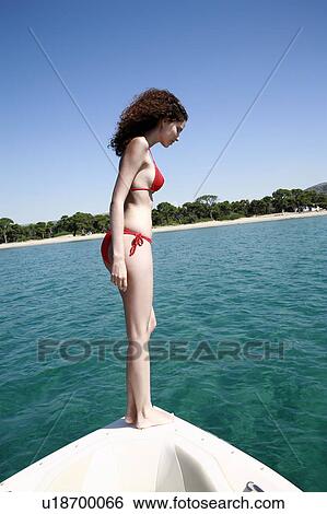 Stock Photograph - Female young adult looking into sea. Fotosearch