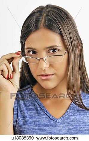 Female young adult looking over eyeglasses View Large Photo Image Stock Image - Female young adult looking over eyeglasses. Fotosearch