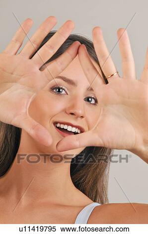 Female young adult looking through hands View Large Photo Image Stock Photography - Female young adult looking through hands. Fotosearch