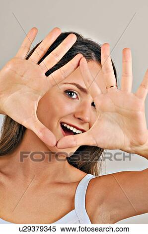 Female young adult looking through hands View Large Photo Image Stock Photography - Female young adult looking through hands. Fotosearch