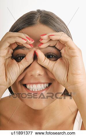 Female young adult; looking through imaginary binoculars View Large Photo Image Stock Photo - Female young adult; looking through imaginary binoculars. Fotosearch