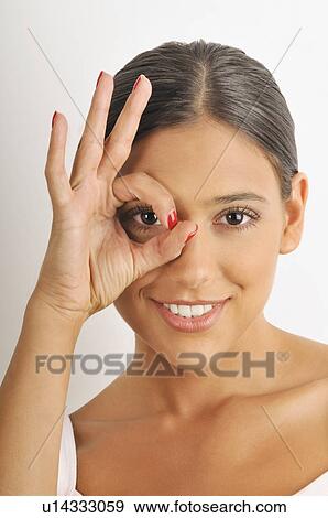 Female young adult; looking through fingers' hole View Large Photo Image Stock Photo - Female young adult; looking through fingers' hole. Fotosearch
