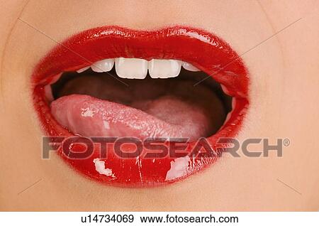 Stock Photo - Female young adult mouth; tongue licking lips. Fotosearch