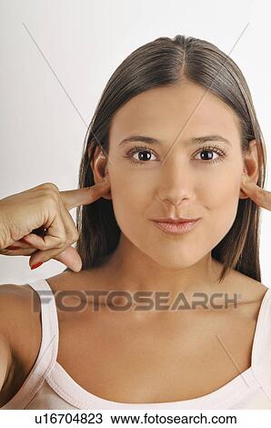 Female young adult; plugging ears with fingers View Large Photo Image Stock Image - Female young adult; plugging ears with fingers. Fotosearch