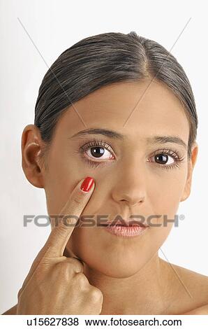 Female young adult; pointing to eye View Large Photo Image Stock Photo - Female young adult; pointing to eye. Fotosearch