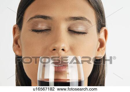 Female young adult smelling a glass of red wine View Large Photo Image Stock Image - Female young adult smelling a glass of red wine. Fotosearch