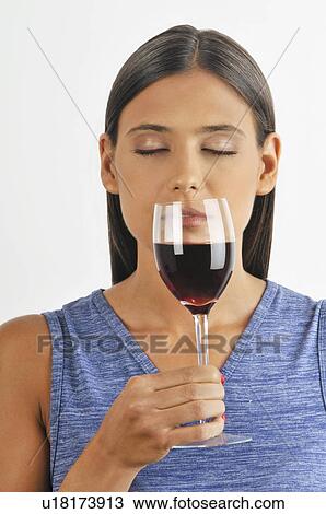 Female young adult smelling a glass of red wine View Large Photo Image Stock Image - Female young adult smelling a glass of red wine. Fotosearch