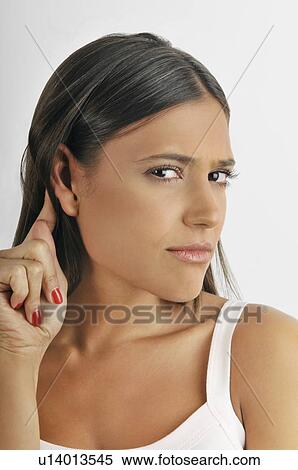 Female young adult; straining to hear View Large Photo Image Stock Photography - Female young adult; straining to hear. Fotosearch