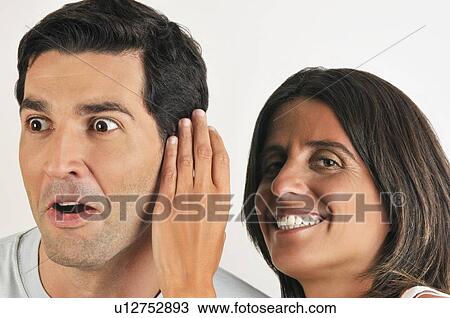 Female young adult whispering in man's ear View Large Photo Image Stock Image - Female young adult whispering in man's ear. Fotosearch