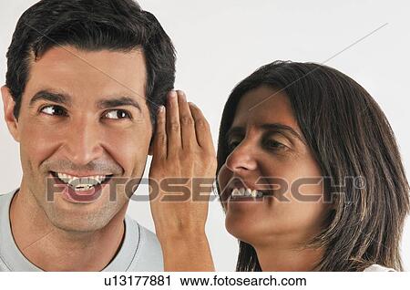 Female young adult whispering in man's ear View Large Photo Image Stock Image - Female young adult whispering in man's ear. Fotosearch