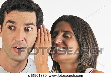 Female young adult whispering in man's ear View Large Photo Image Stock Image - Female young adult whispering in man's ear. Fotosearch