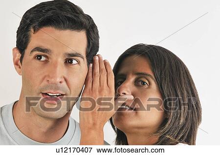 Female young adult whispering in man's ear View Large Photo Image Stock Photo - Female young adult whispering in man's ear. Fotosearch