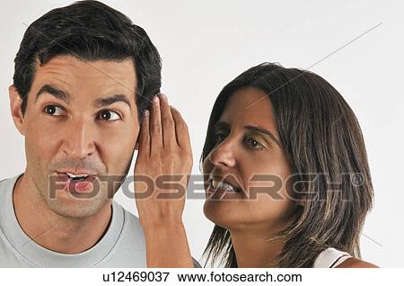 Female young adult whispering in man's ear View Large Photo Image Stock Photo - Female young adult whispering in man's ear. Fotosearch