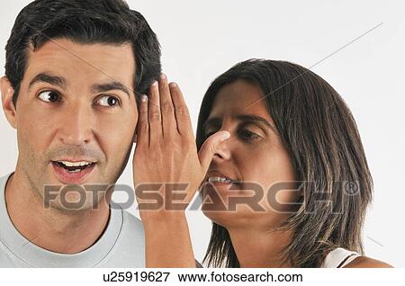 Female young adult whispering in man's ear View Large Photo Image Stock Photo - Female young adult whispering in man's ear. Fotosearch