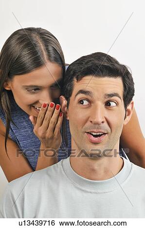 Female young adult whispering in man's ear View Large Photo Image Stock Photograph - Female young adult whispering in man's ear. Fotosearch