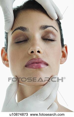 Hands wearing surgical gloves holding young woman's face View Large Photo Image Stock Image - Hands wearing surgical gloves holding young woman's face. Fotosearch
