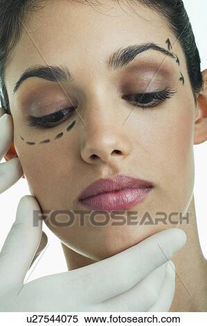 Hands with surgical gloves on patient's face with distance marker View Large Photo Image Stock Photography - Hands with surgical gloves on patient's face with distance marker. Fotosearch