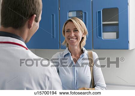 Picture - Happy patient visiting doctor. Fotosearch