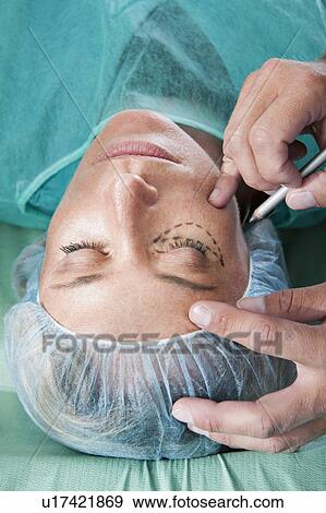 Stock Photo - Incision lines on face in operating room. Fotosearch