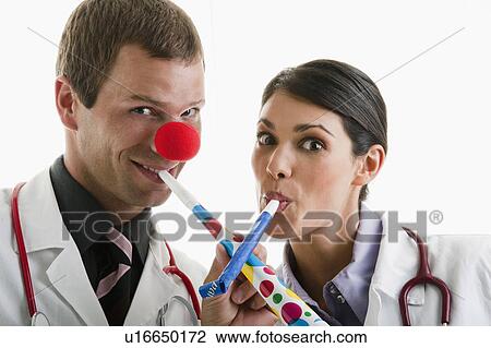 Male and female doctors with party toys View Large Photo Image Stock Image - Male and female doctors with party toys. Fotosearch