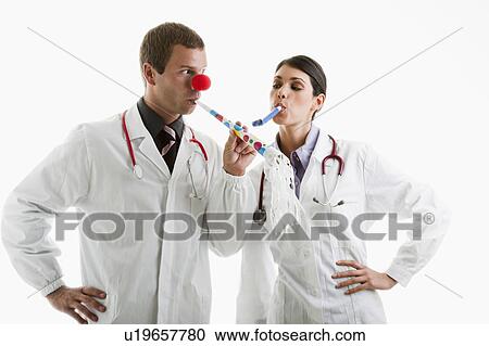 Male and female doctors with party toys View Large Photo Image Stock Image - Male and female doctors with party toys. Fotosearch