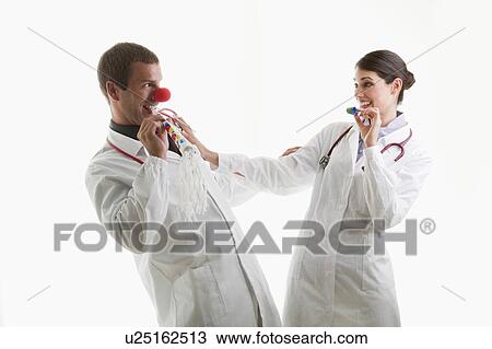 Male and female doctors with party toys View Large Photo Image Stock Image - Male and female doctors with party toys. Fotosearch