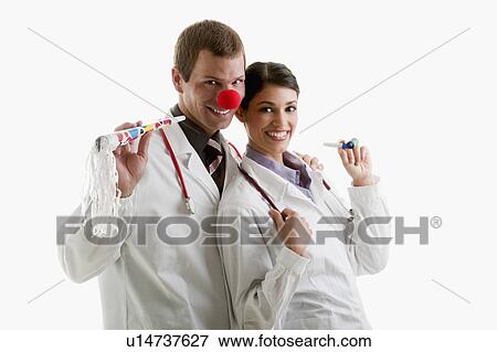 Male and female doctors with party toys View Large Photo Image Stock Photo - Male and female doctors with party toys. Fotosearch