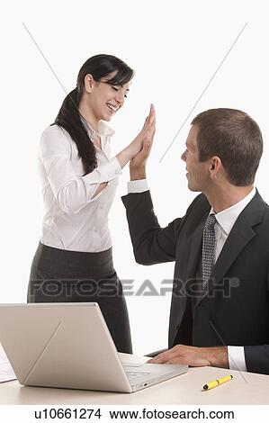 Man and woman doing high five View Large Photo Image Picture - Man and woman doing high five. Fotosearch