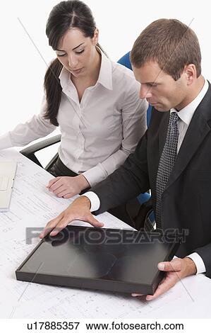 Stock Photo - Man and woman looking at solar panel . Fotosearch