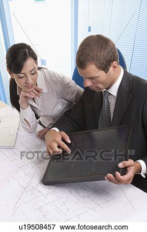 Man and woman looking at solar panel View Large Photo Image Stock Photo - Man and woman looking at solar panel. Fotosearch