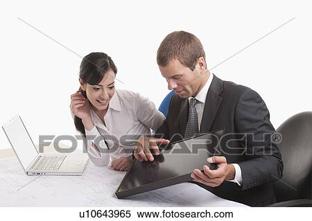 Stock Photography - Man and woman looking at solar panel. Fotosearch