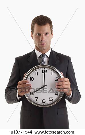 Man holding clock View Large Photo Image Picture - Man holding clock. Fotosearch