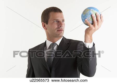 Stock Image - Man holding globe. Fotosearch