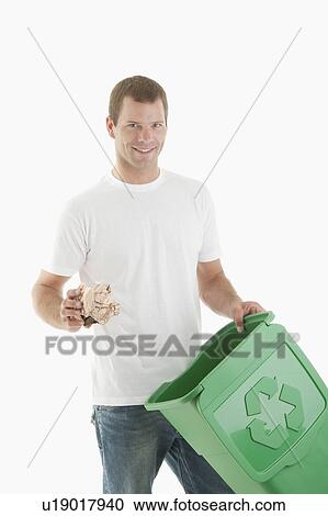 Man throwing paper in the recycling bin View Large Photo Image Stock Image - Man throwing paper in the recycling bin. Fotosearch