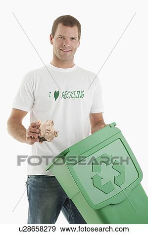 Man throwing paper in the recycling bin View Large Photo Image Stock Photo - Man throwing paper in the recycling bin. Fotosearch