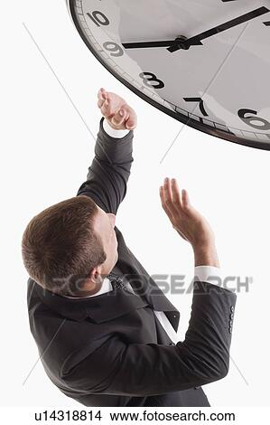 Man underneath clock View Large Photo Image Picture - Man underneath clock. Fotosearch