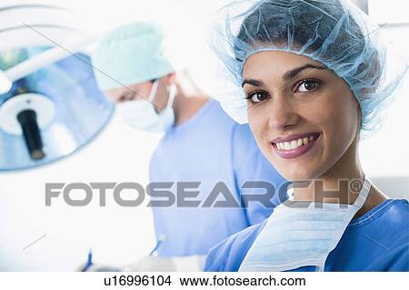 Picture - Medical personnel in operating room. Fotosearch