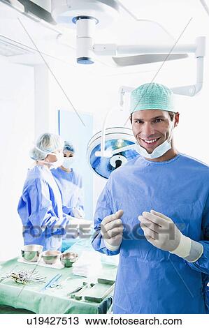 Stock Image - Medical personnel in operating room. Fotosearch
