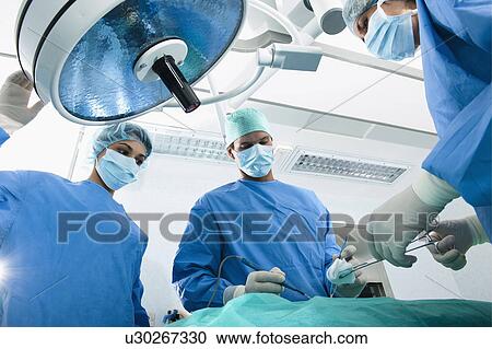 Medical personnel in operating room View Large Photo Image Stock Image - Medical personnel in operating room. Fotosearch