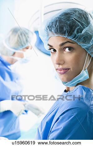 Stock Photo - Medical personnel in operating room. Fotosearch