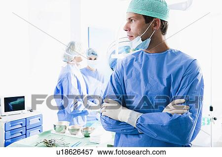 Stock Photo - Medical personnel in operating room. Fotosearch