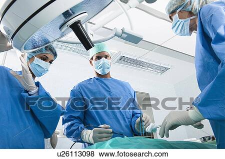 Stock Photo - Medical personnel in operating room. Fotosearch