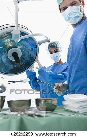 Stock Photo - Medical personnel in operating room. Fotosearch
