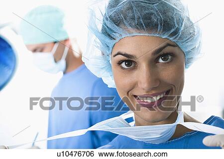 Stock Photograph - Medical personnel in operating room. Fotosearch