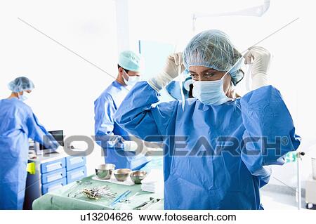Stock Photograph - Medical personnel in operating room. Fotosearch