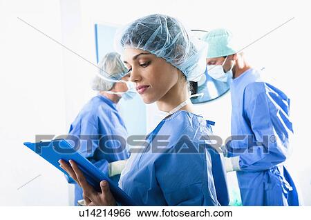 Medical personnel in operating room View Large Photo Image Stock Photograph - Medical personnel in operating room. Fotosearch