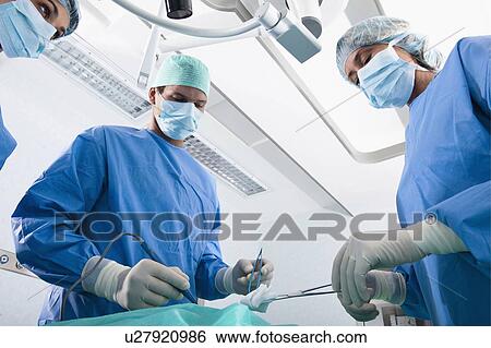 Medical personnel in operating room View Large Photo Image Stock Photograph - Medical personnel in operating room. Fotosearch
